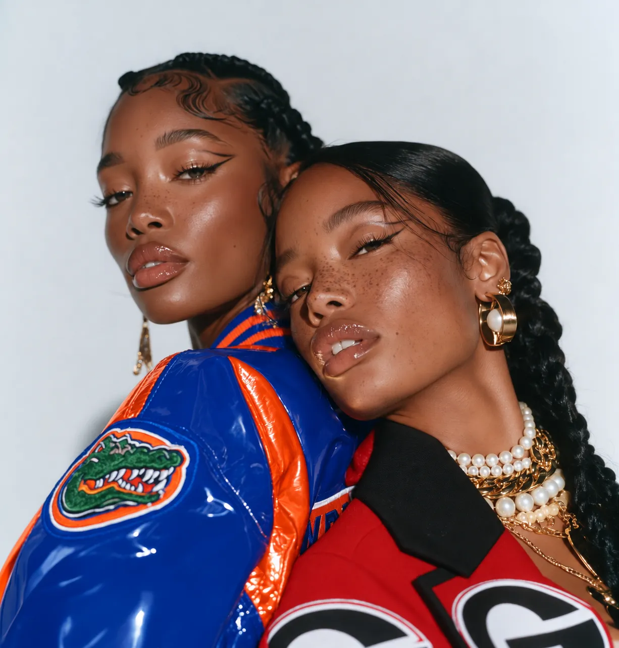 Two women in Florida and Georgia varsity jackets