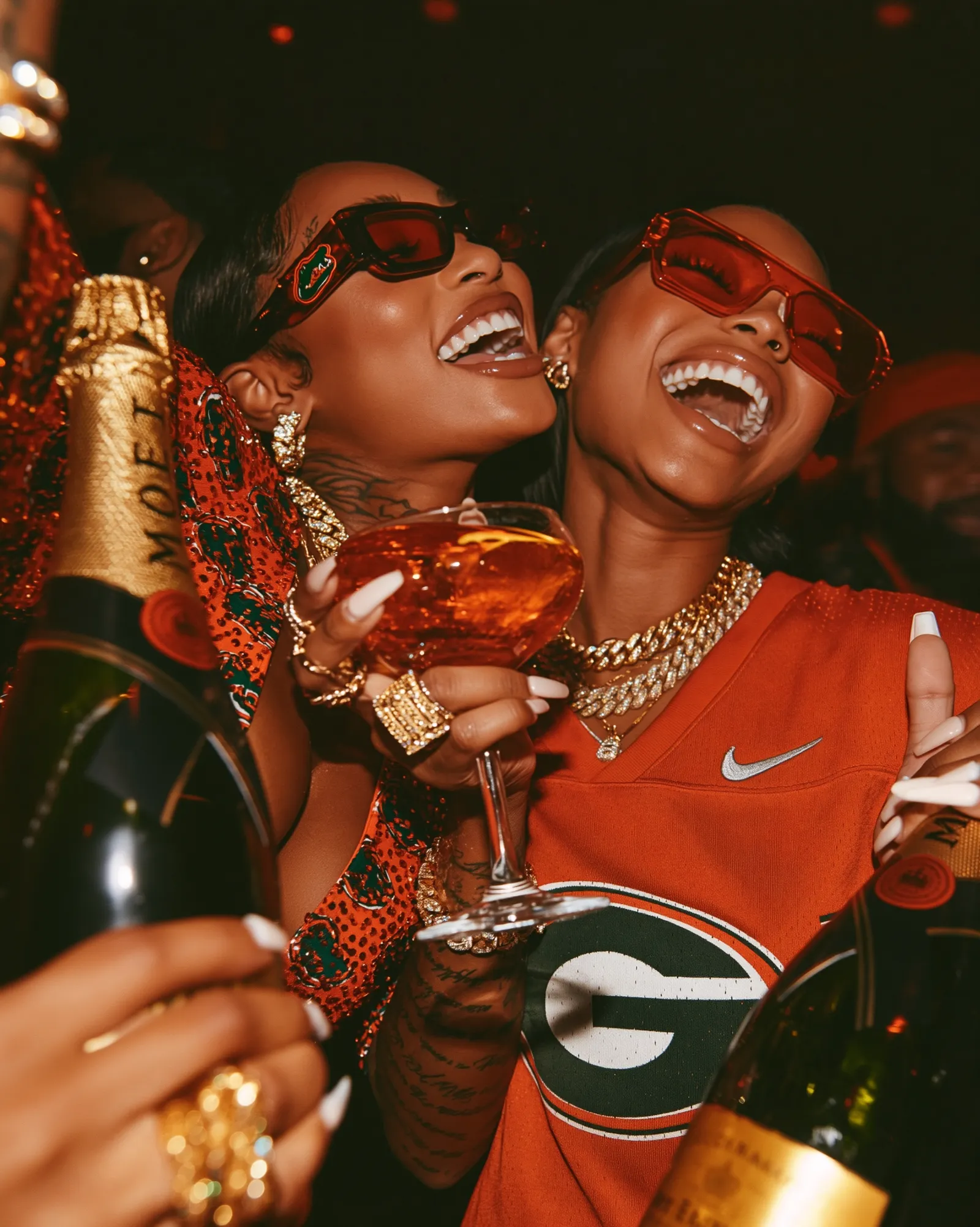 Laughing guests in Georgia orange toasting with champagne